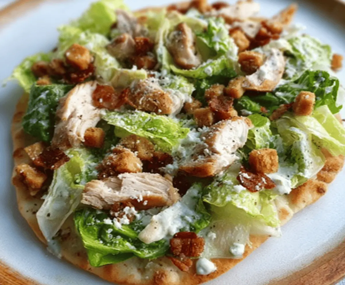 Delicious Chicken Caesar Flatbread topped with crispy chicken, romaine lettuce, and creamy Caesar dressing on a flatbread crust.