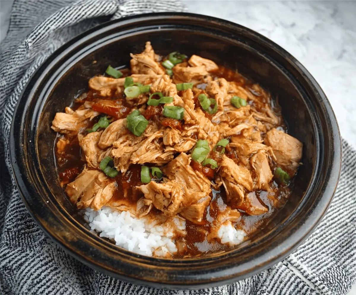 Delicious Crock Pot Bourbon Chicken served with vegetables and rice, perfect for a hearty dinner.