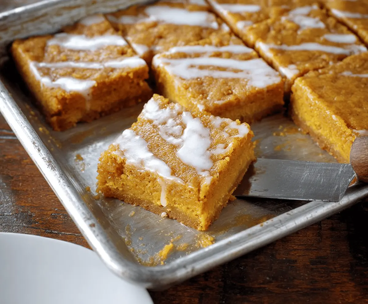 Delicious Pumpkin Gooey Butter Bars with creamy pumpkin filling and a golden crust, perfect for fall desserts