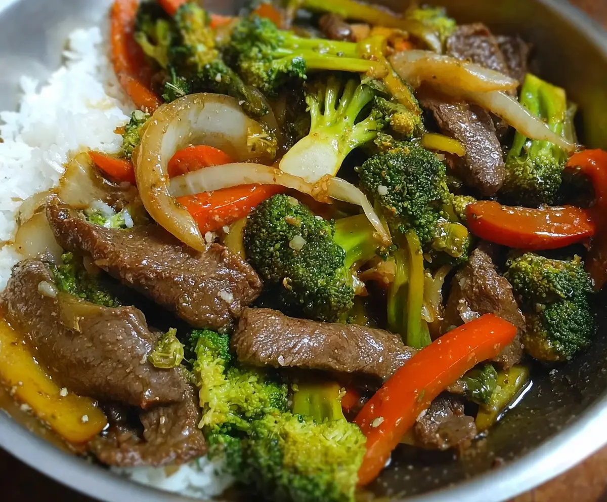 Delicious easy beef stir fry with colorful vegetables in a sizzling skillet.