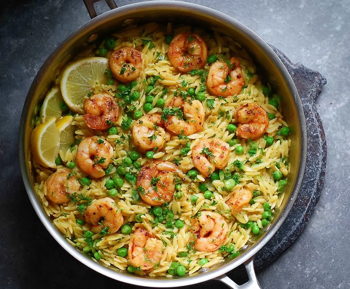 Delicious One Pot Pea and Shrimp Orzo served in a rustic bowl, highlighting fresh ingredients and vibrant colors.